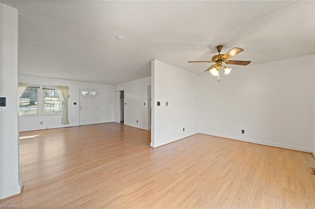 unfurnished living room featuring a ceiling fan, light wood-style floors, and baseboards