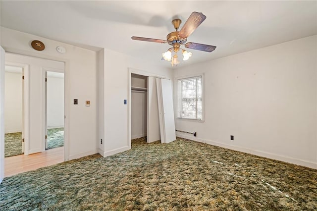 unfurnished bedroom featuring carpet flooring, a ceiling fan, and baseboards