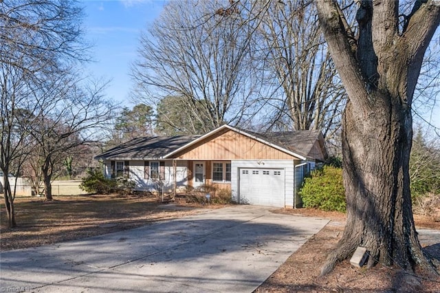 exterior space with board and batten siding, concrete driveway, and a garage