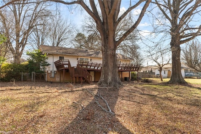 view of yard with stairway, a wooden deck, and fence