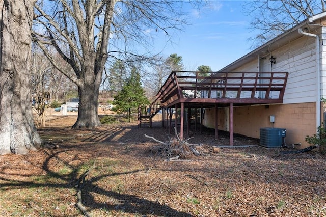 view of yard with a wooden deck, central AC, and stairs