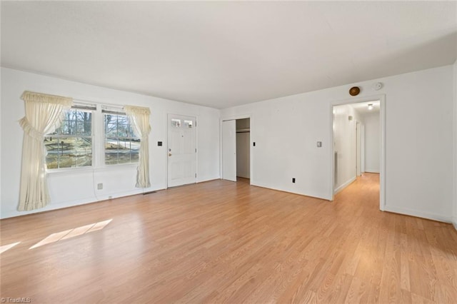 unfurnished living room featuring light wood-style flooring