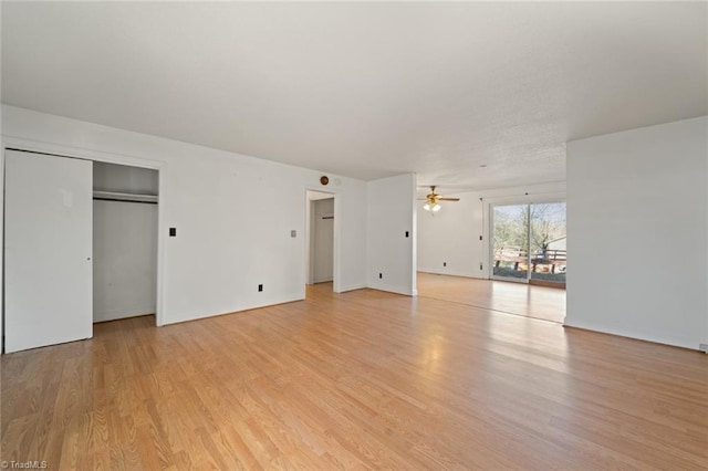 interior space featuring access to exterior, light wood-style flooring, and baseboards