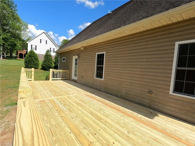 wooden terrace with a lawn
