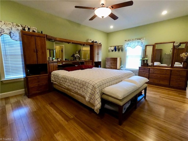 bedroom featuring wood finished floors, a ceiling fan, and recessed lighting