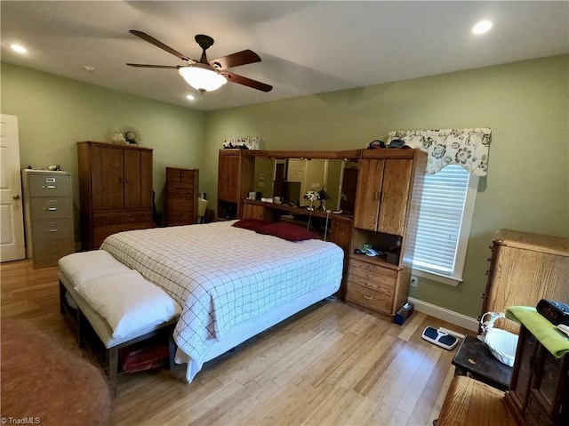 bedroom featuring light wood-style floors, recessed lighting, a ceiling fan, and baseboards