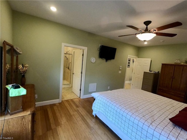bedroom featuring wood finished floors, baseboards, ensuite bath, recessed lighting, and ceiling fan