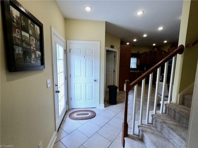 foyer featuring stairs, tile patterned flooring, recessed lighting, and baseboards