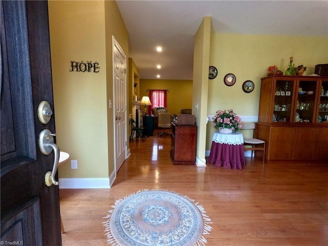 entrance foyer with light wood-style flooring and baseboards