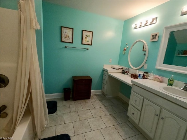bathroom with tile patterned floors, vanity, and baseboards