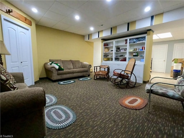 living area with carpet floors, recessed lighting, and a paneled ceiling