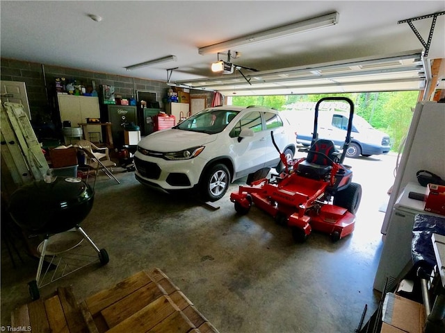 garage with concrete block wall and a garage door opener