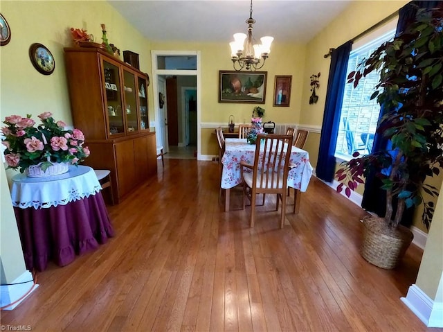 dining space featuring a chandelier and light wood-style flooring
