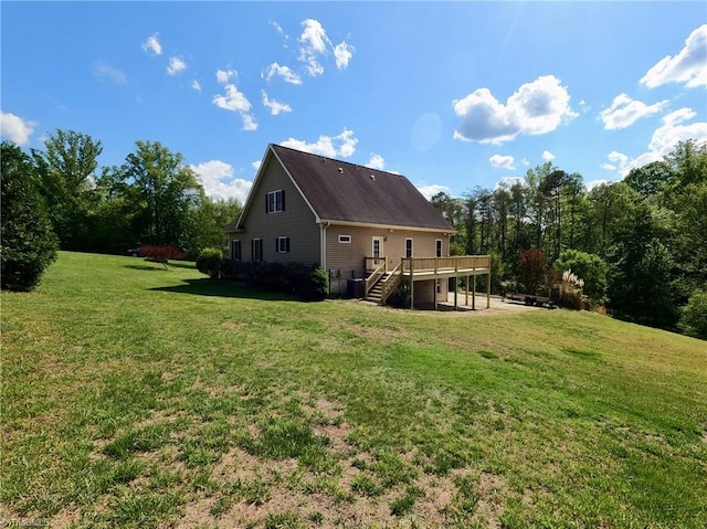 back of house featuring a deck, stairs, and a yard