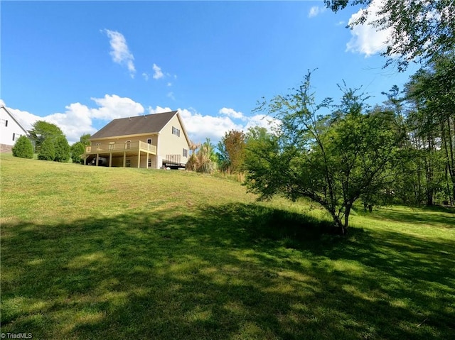 view of grassy yard with a deck