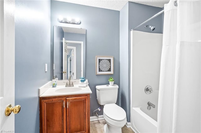 bathroom featuring shower / bath combo, vanity, toilet, and a textured ceiling