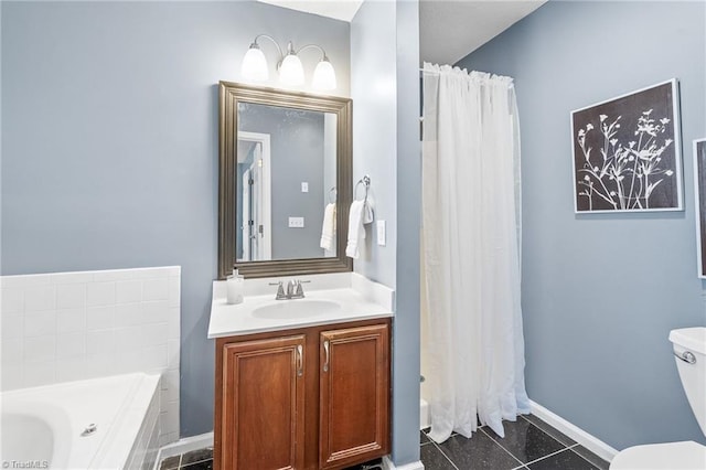 bathroom featuring tile patterned flooring, toilet, vanity, baseboards, and a bath