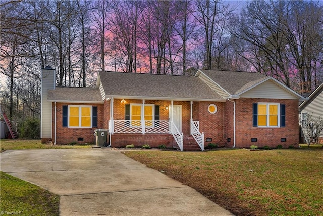 single story home with a porch, brick siding, a yard, crawl space, and a chimney