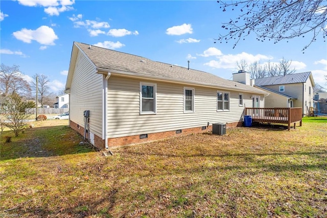 back of house featuring a chimney, crawl space, a deck, cooling unit, and a yard