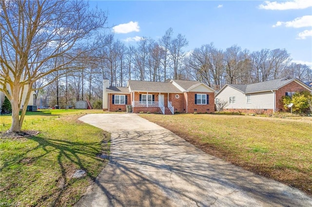 ranch-style home featuring a chimney, covered porch, concrete driveway, crawl space, and a front lawn