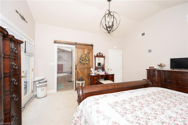 bedroom featuring a chandelier, vaulted ceiling, light colored carpet, a barn door, and connected bathroom