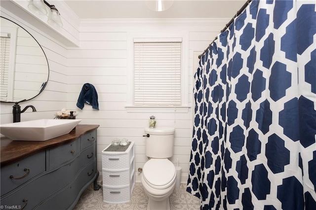 bathroom featuring ornamental molding, vanity, and toilet