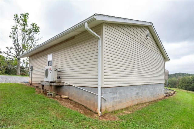 view of home's exterior featuring ac unit and a lawn