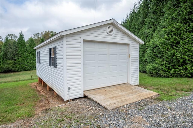 garage featuring a lawn