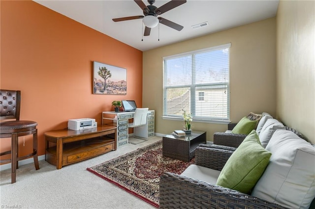 office area featuring carpet floors, visible vents, baseboards, and a ceiling fan