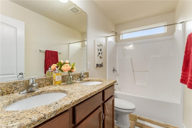 full bathroom featuring toilet, double vanity, a sink, and shower / bathing tub combination