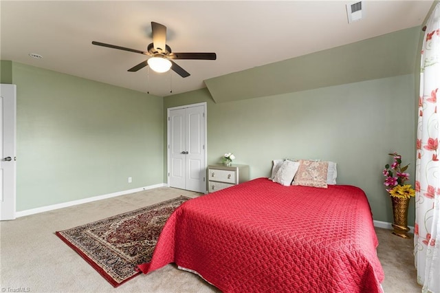 carpeted bedroom featuring visible vents, a closet, baseboards, and a ceiling fan