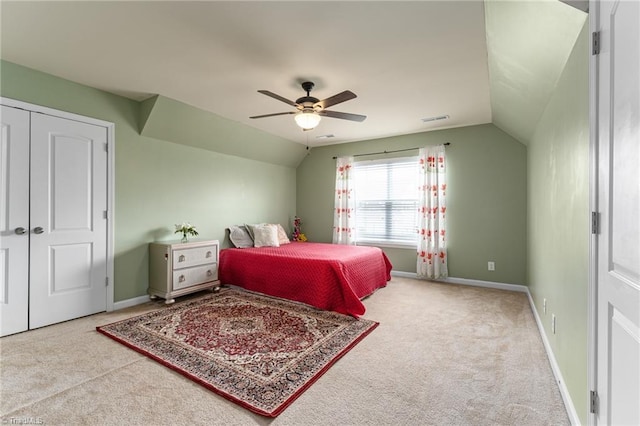 bedroom with carpet floors, lofted ceiling, and visible vents