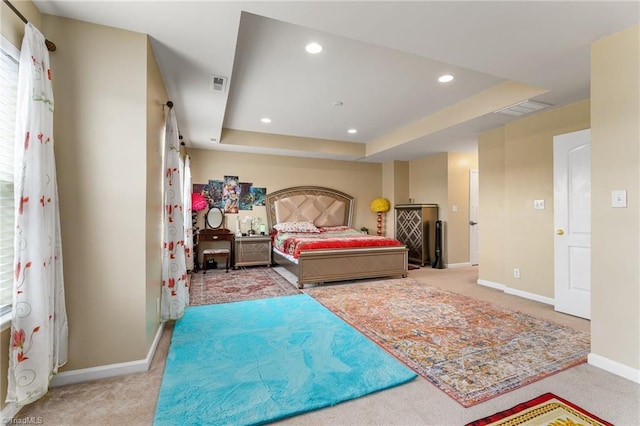 bedroom featuring light colored carpet, recessed lighting, visible vents, baseboards, and a raised ceiling