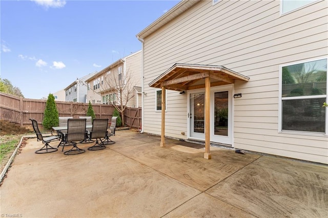 view of patio with outdoor dining space and a fenced backyard