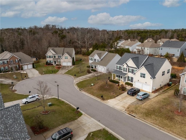 drone / aerial view with a forest view and a residential view