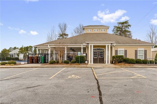 view of property featuring uncovered parking and fence