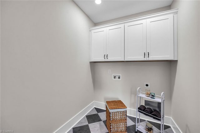 clothes washing area featuring cabinets, hookup for a washing machine, and electric dryer hookup