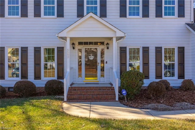 doorway to property featuring a yard