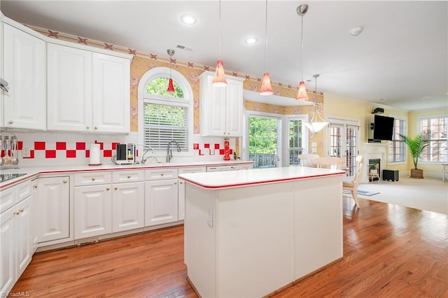 221 Oakmont Park Ct, Kernersville, NC 27284 - kitchen featuring open floor plan, light countertops, white cabinetry, recessed lighting, and crown molding