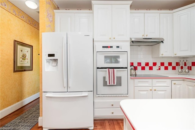 221 Oakmont Park Ct, Kernersville, NC 27284 - kitchen with white appliances, wood finished floors, under cabinet range hood, and white cabinetry