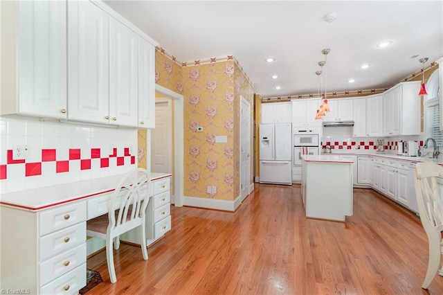 221 Oakmont Park Ct, Kernersville, NC 27284 - kitchen with white refrigerator with ice dispenser, a center island, white cabinetry, wallpapered walls, and light countertops