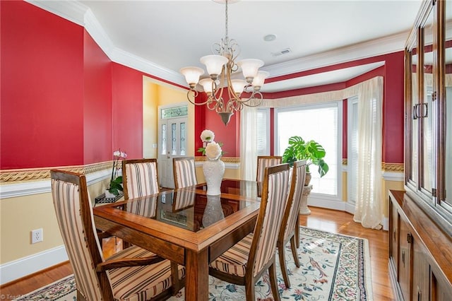 221 Oakmont Park Ct, Kernersville, NC 27284 - dining space featuring crown molding, a chandelier, light wood finished floors, and baseboards