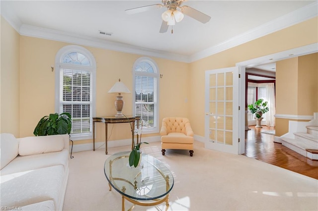221 Oakmont Park Ct, Kernersville, NC 27284 - carpeted living area featuring crown molding, plenty of natural light, baseboards, a ceiling fan, and french doors