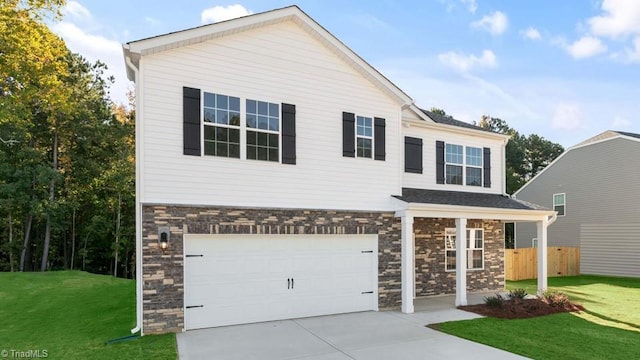 view of front of home with a garage and a front yard