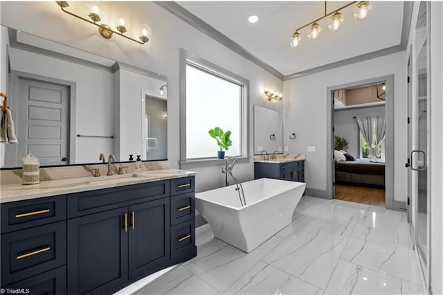 bathroom with ornamental molding, vanity, and a bathtub