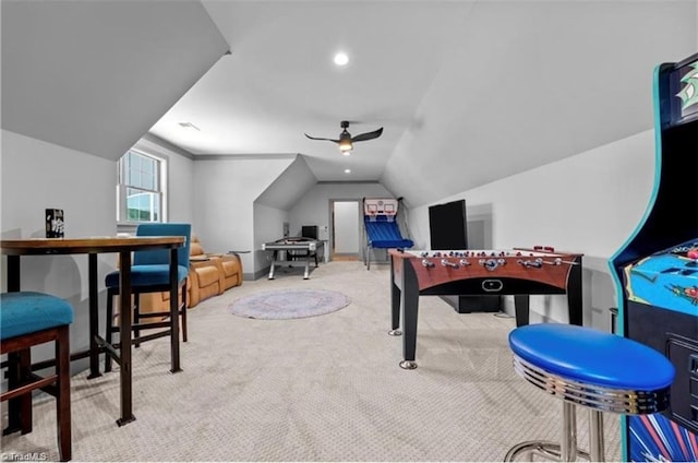 game room with vaulted ceiling, light carpet, and ceiling fan