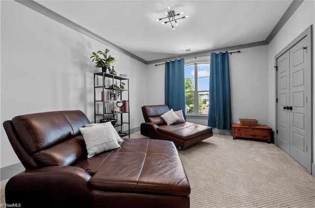 sitting room featuring ornamental molding and light colored carpet