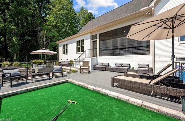 wooden deck with an outdoor living space and a sunroom