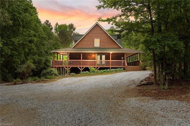view of front of home with french doors, driveway, and covered porch