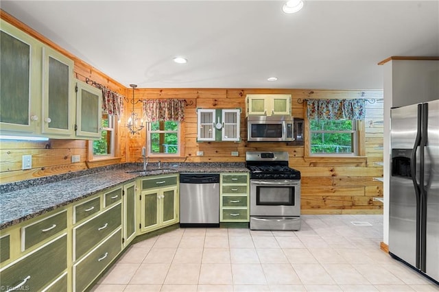 kitchen featuring green cabinetry, appliances with stainless steel finishes, a healthy amount of sunlight, and a sink